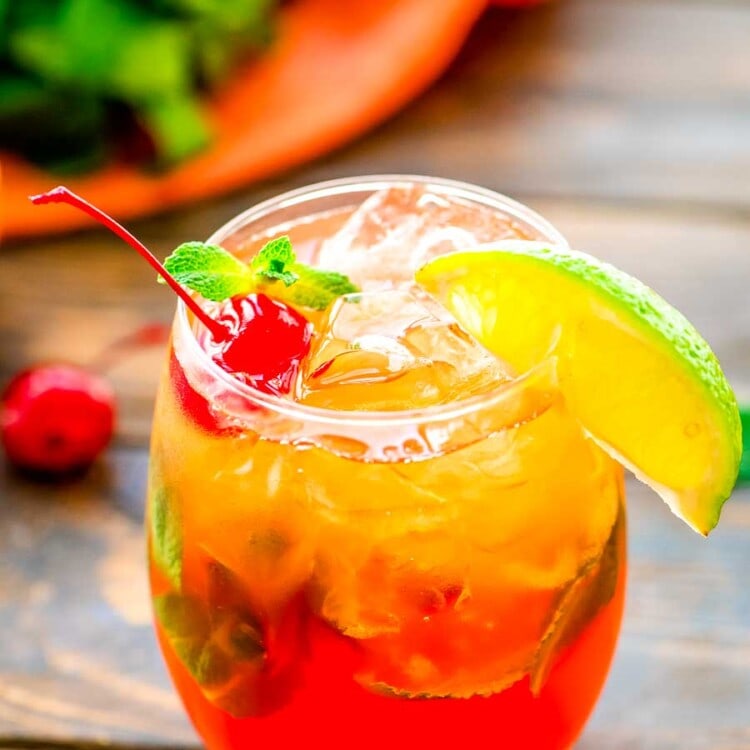 Mai Tai Drink in glass with a lime wedge and cherry