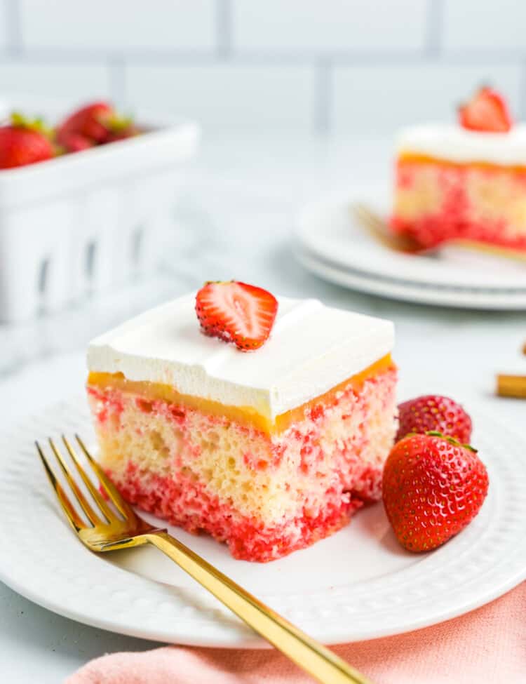 A piece of Strawberry Poke Cake on Plate