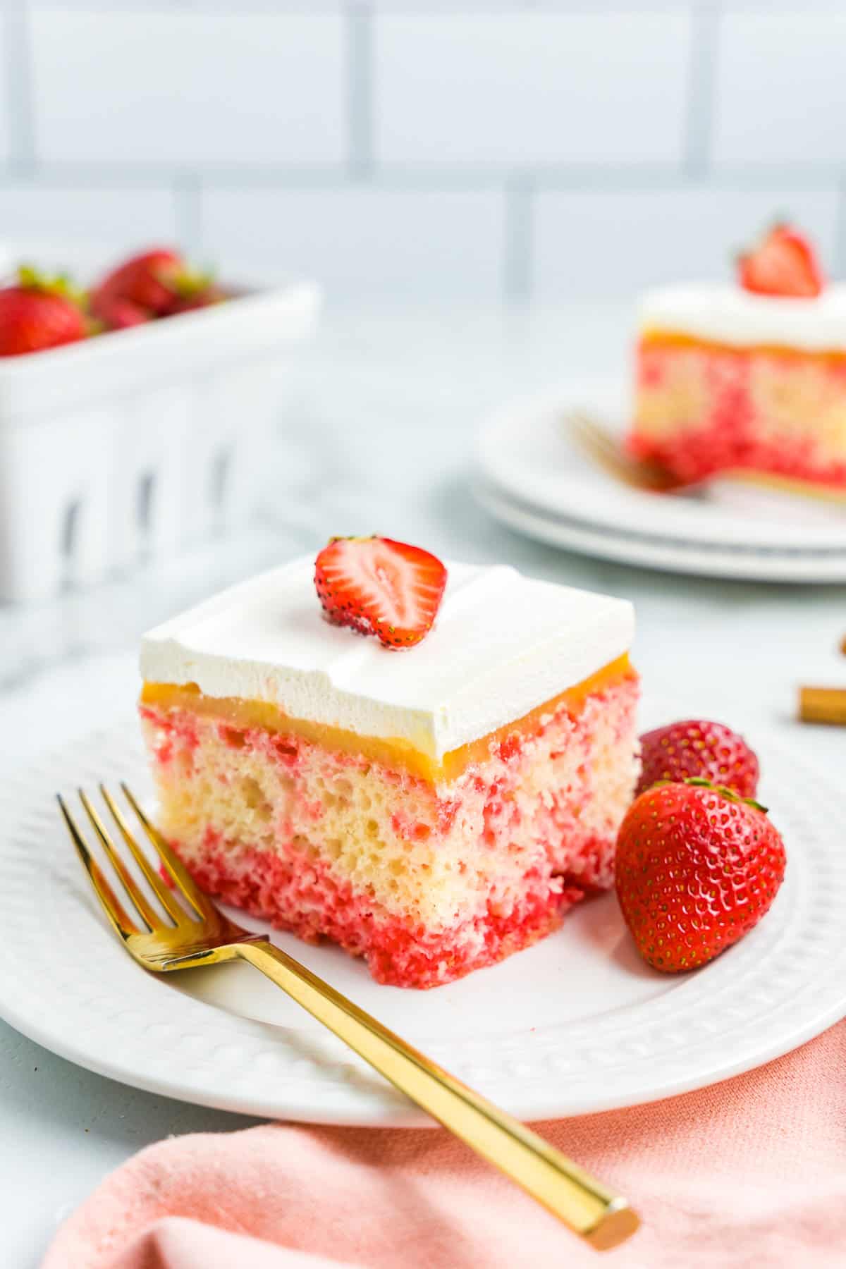 A piece of Strawberry Poke Cake on Plate
