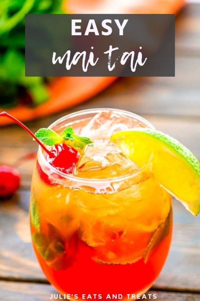 Mai tai cocktail in a glass with a lime wedge and cherry