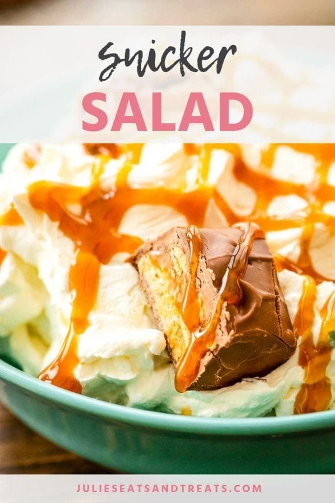 Snicker salad in a blue bowl topped with snicker chunks and caramel sauce