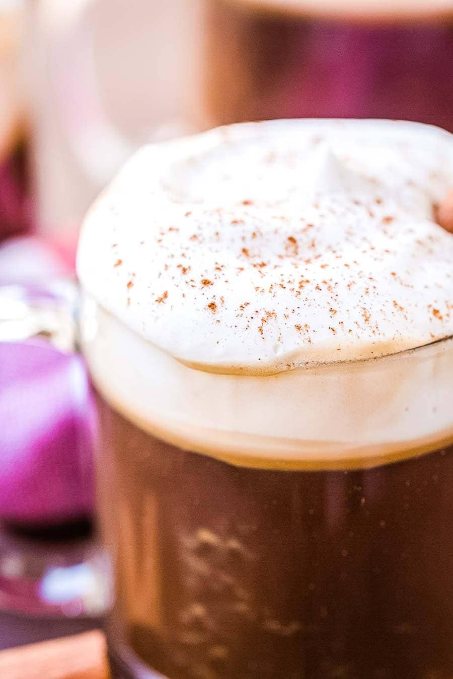 Easy close up of a coffee mug with coffee cocktail topped with whipped cream