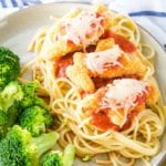 Chicken Parmesan with Dino Buddies Plated next to broccoli