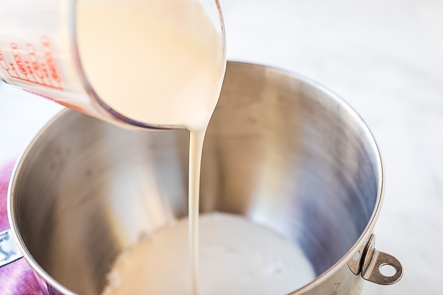 Heavy cream poured into mixing bowl