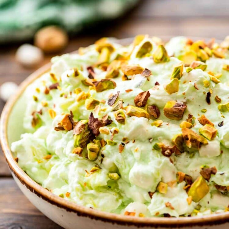 Bowl of watergate salad topped with pistachio
