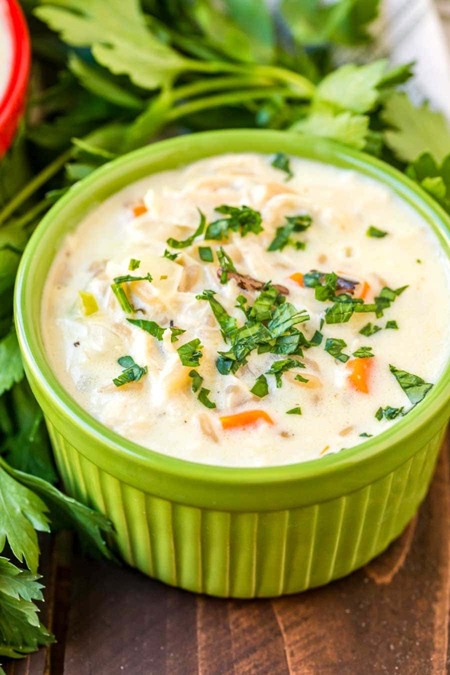 Green bowl with Wild Rice Soup topped with chopped parsley