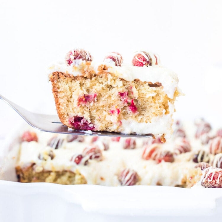 Piece of Cranberry Cake on spatula being lifted out of a baking dish