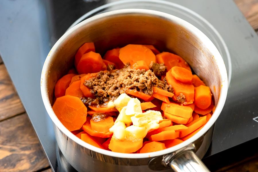 Saucepan with carrots, butter and brown sugar