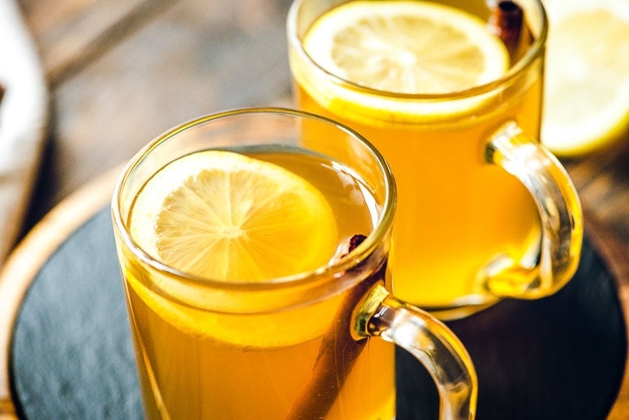 Top View of Mug of Hot Toddy with lemon slice and cinnamon stick