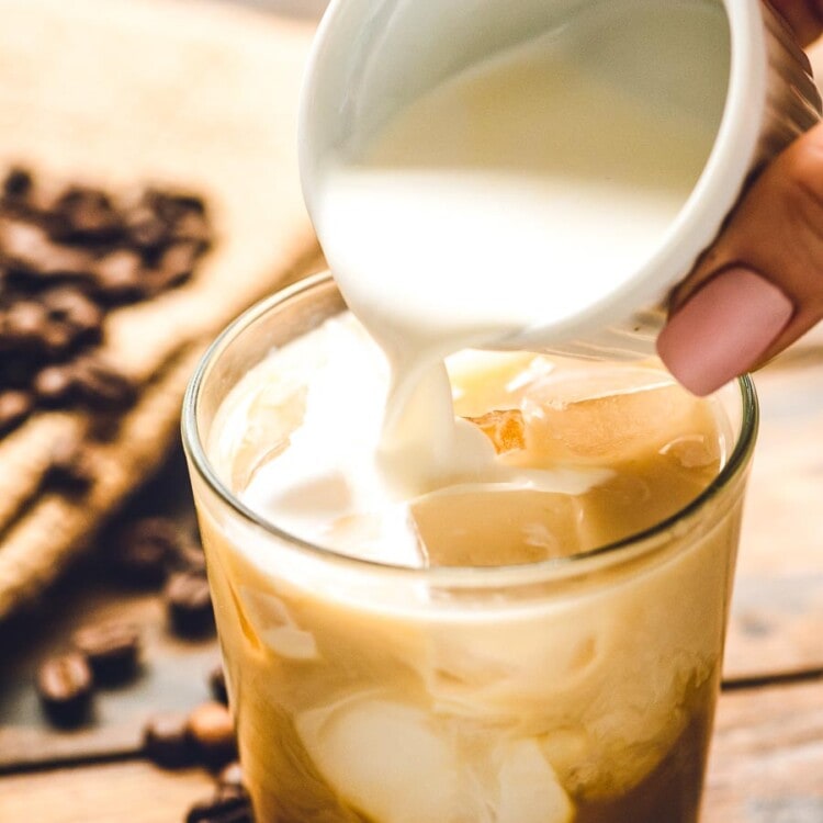 Cream being poured into White Russian cocktail