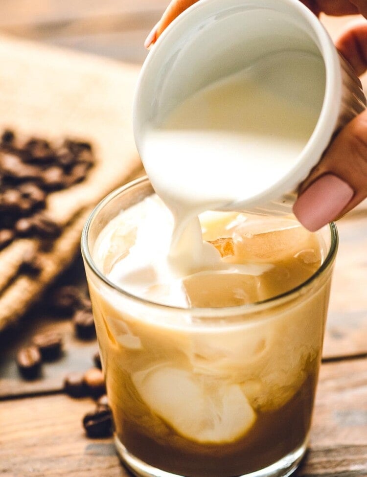 Cream being poured into White Russian cocktail