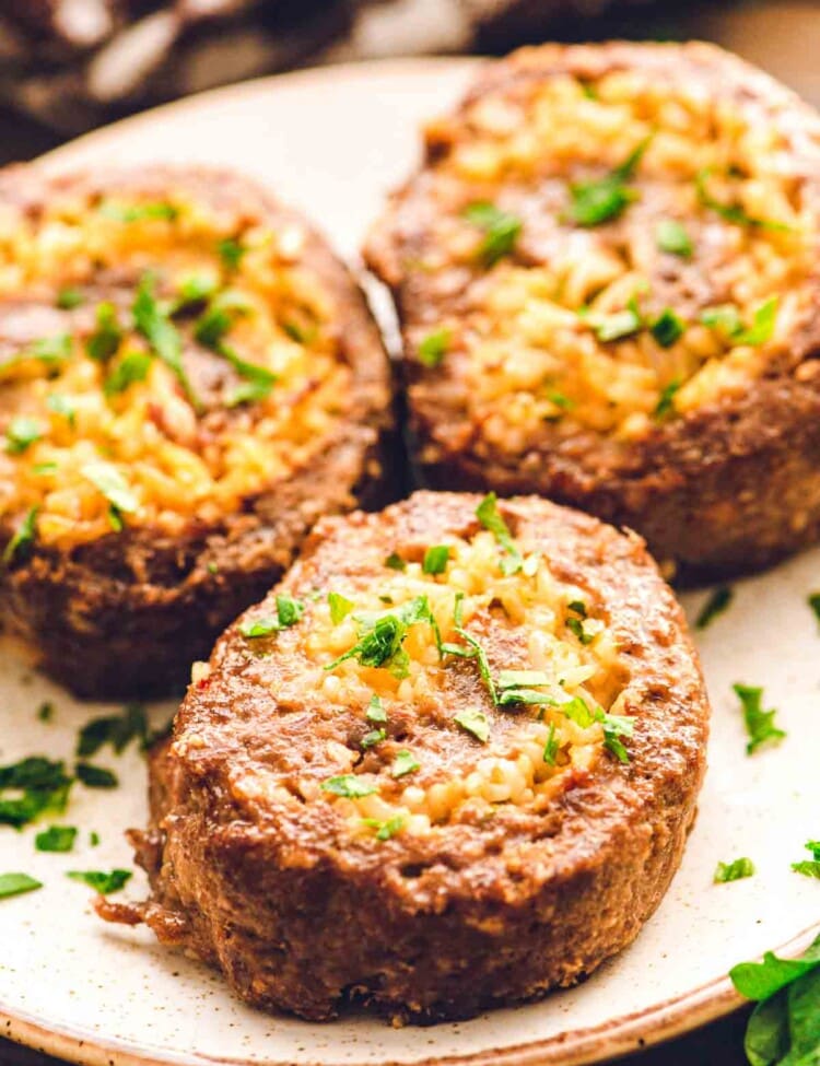 Plate with three pinwheel meatloaves on it