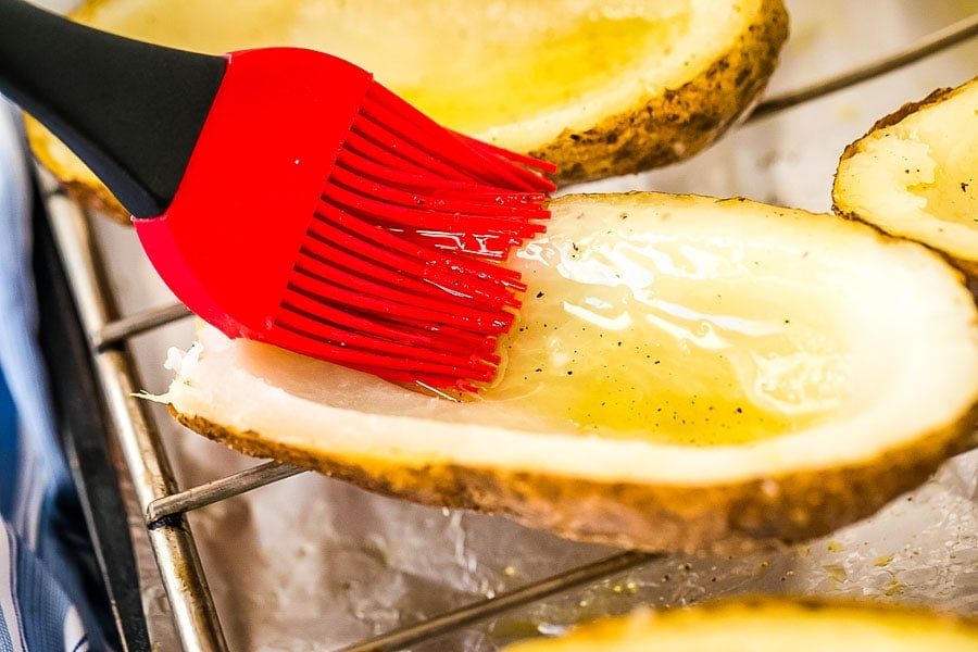 Potato inside being brushed with olive oil