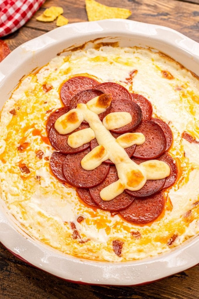 Overhead image of football pepperoni pizza dip in pie plate.