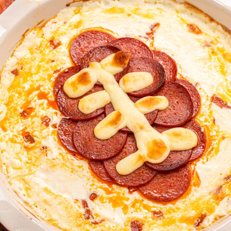 Overhead image of football pepperoni pizza dip in pie plate.