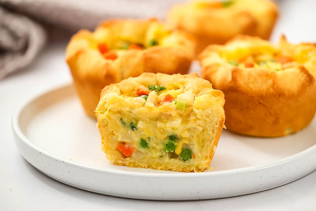 Mini Chicken Pot Pies sliced open on white plate