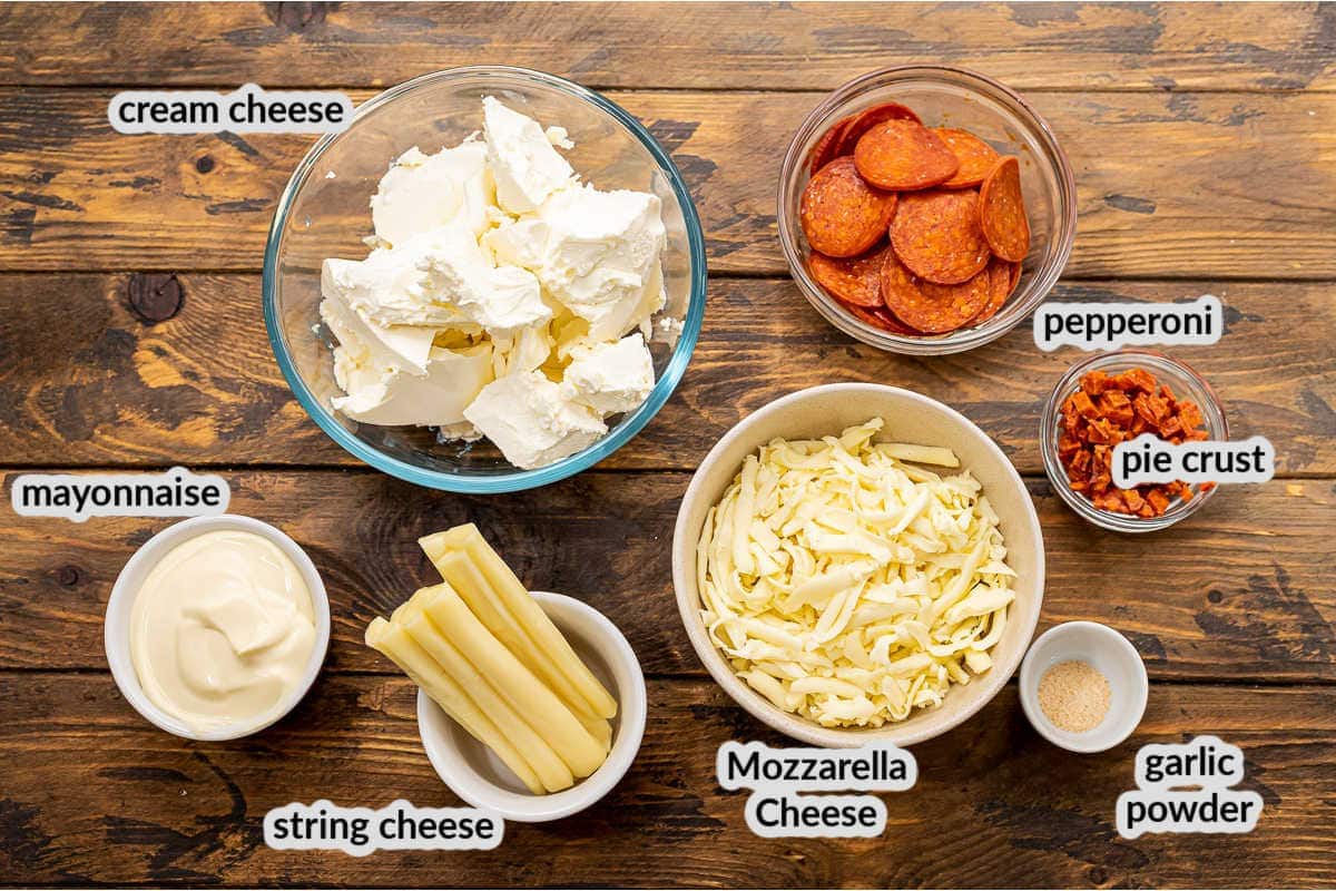 Overhead image of Pepperoni Pizza Dip Ingredients on wooden background