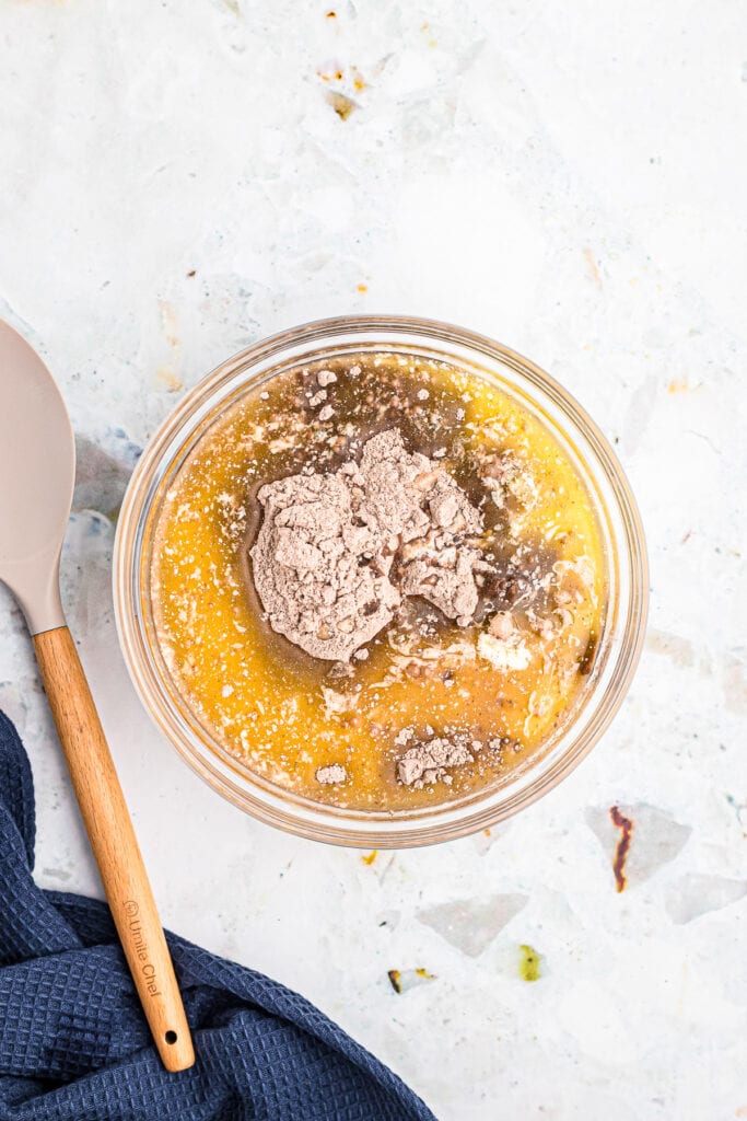 Overhead image of glass bowl with ingredients for brownies before mixing