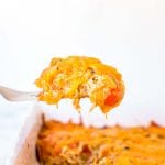 a bite of king ranch casserole on a fork over the top of the casserole