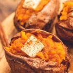 Air Fryer Baked Sweet Potato cut open and topped with butter and sprinkled with cinnamon