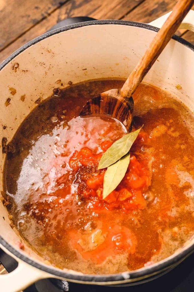 bay leaves and ingredients like tomatoes broth hamburger in dutch oven 