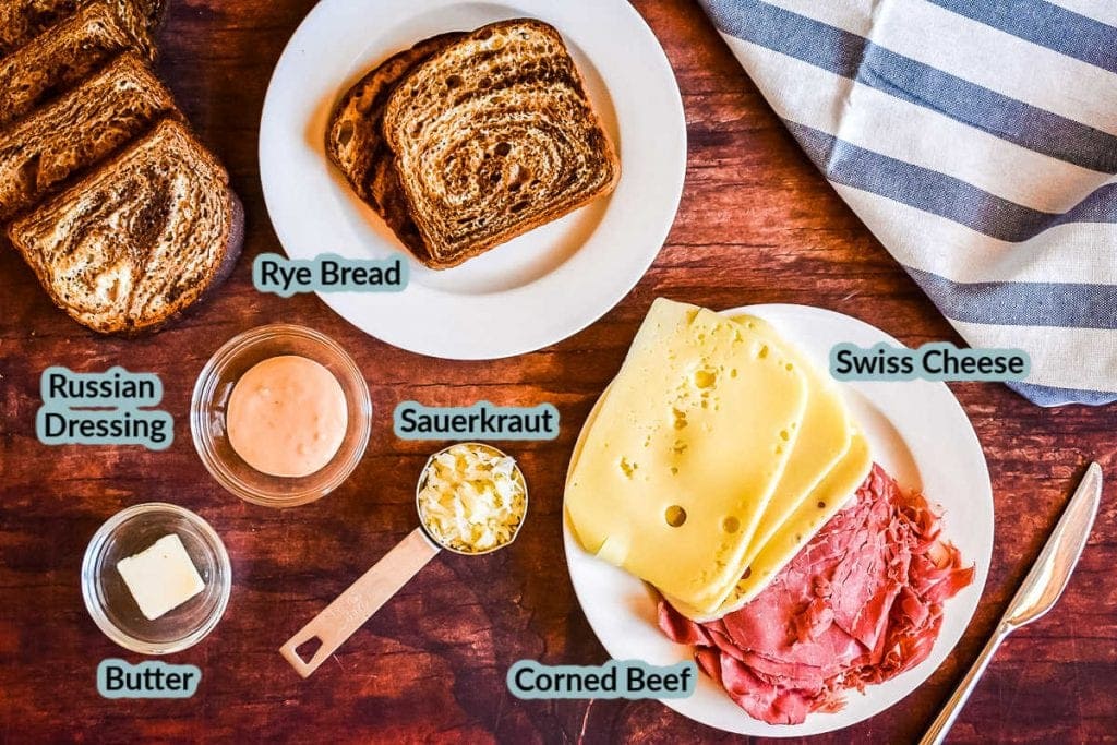 Overhead photo of all the ingredients for sandwich on wood backdrop