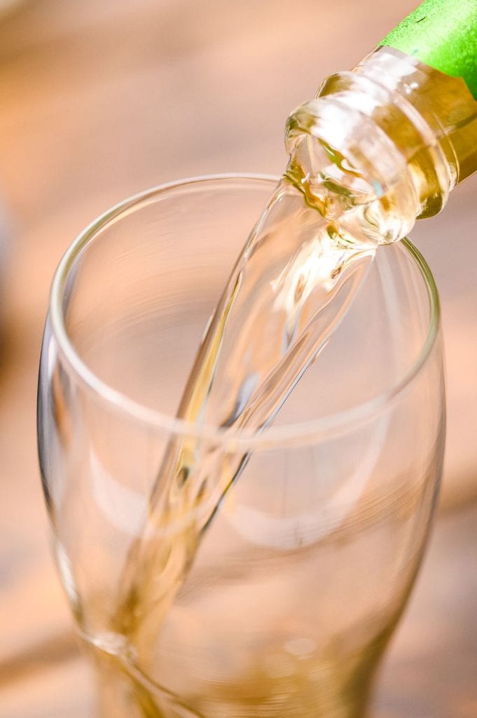 Pouring cider in a pint glass