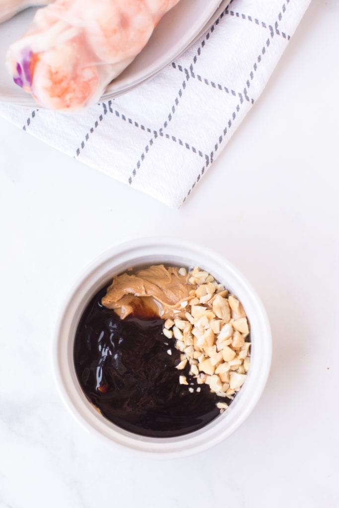 Ingredients for peanut sauce in white bowl on light background