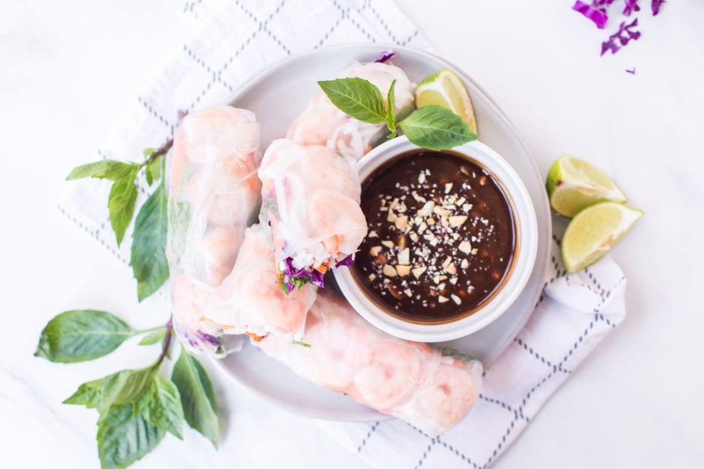 Plate with fresh spring rolls and peanut sauce