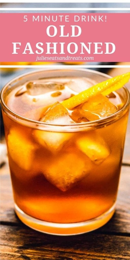 Old fashioned drink in a clear glass with ice cubes and an orange rind