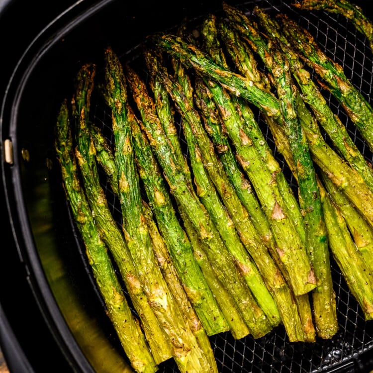 Roasted Asparagus in black air fryer basket