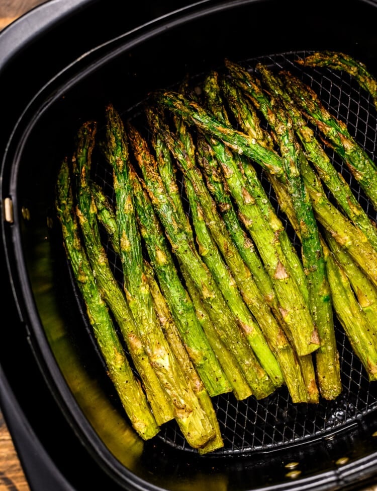 Roasted Asparagus in black air fryer basket