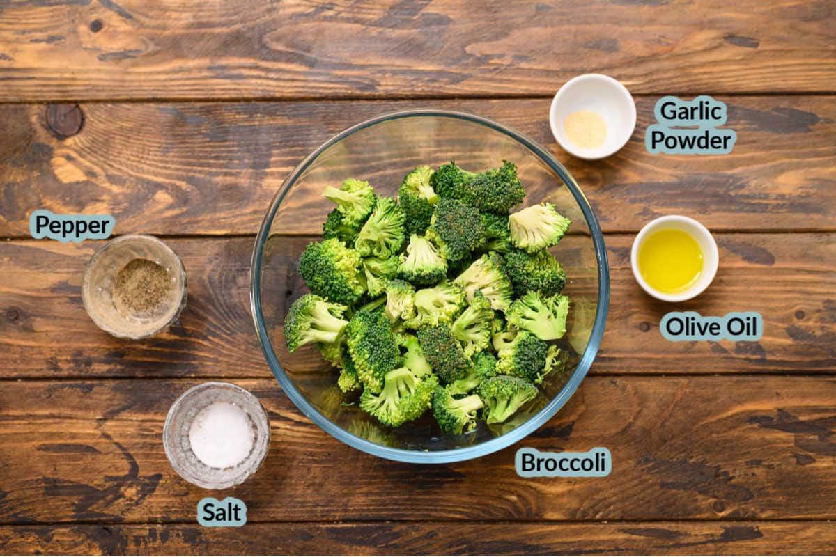 Wood background with ingredients to make air fryer broccoli