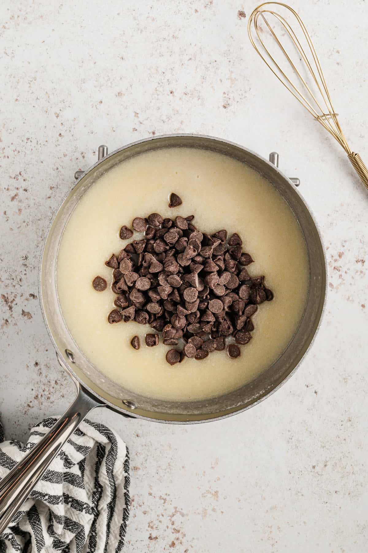 Adding chocolate chips to saucepan for Chocolate Cherry Bars frosting