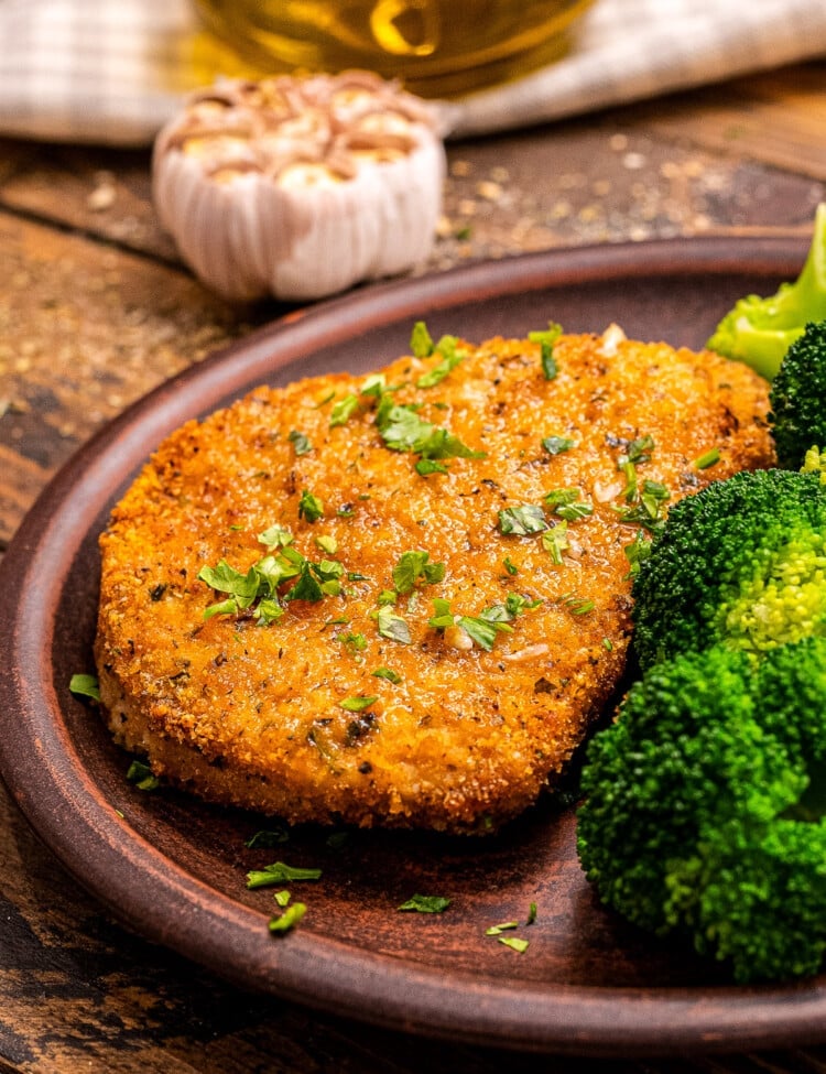 Plate with breaded pork chops and broccoli on it