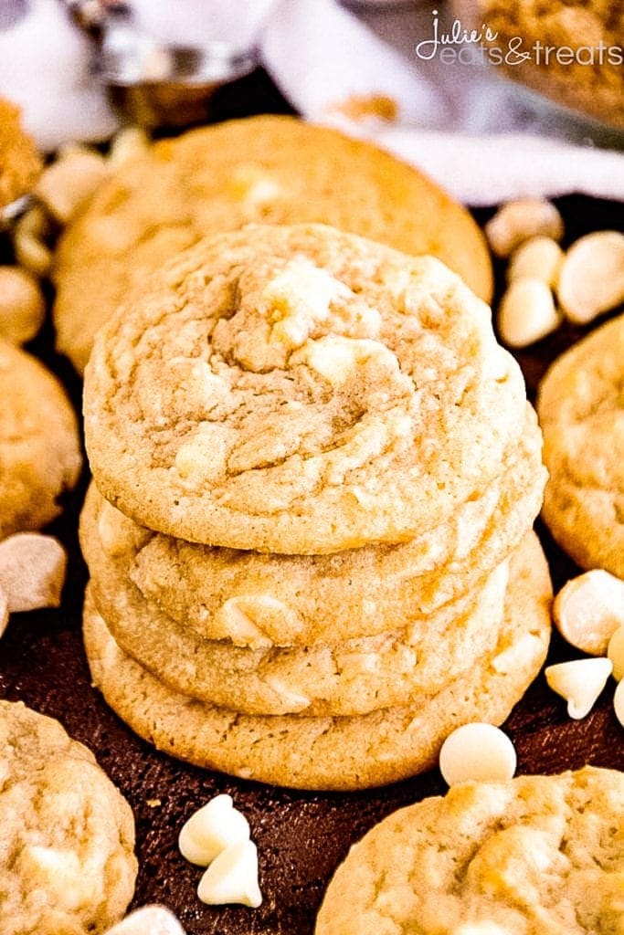 Stack of White Chocolate Macadamia Nut Cookies with more cookies laying next to it