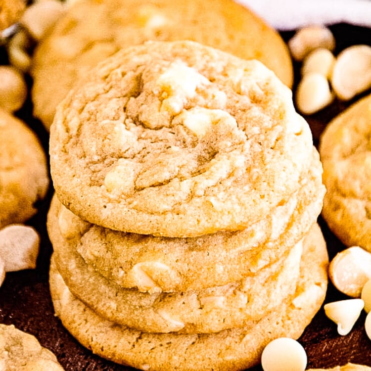 Stack of White Chocolate Macadamia Nut Cookies with more cookies laying next to it