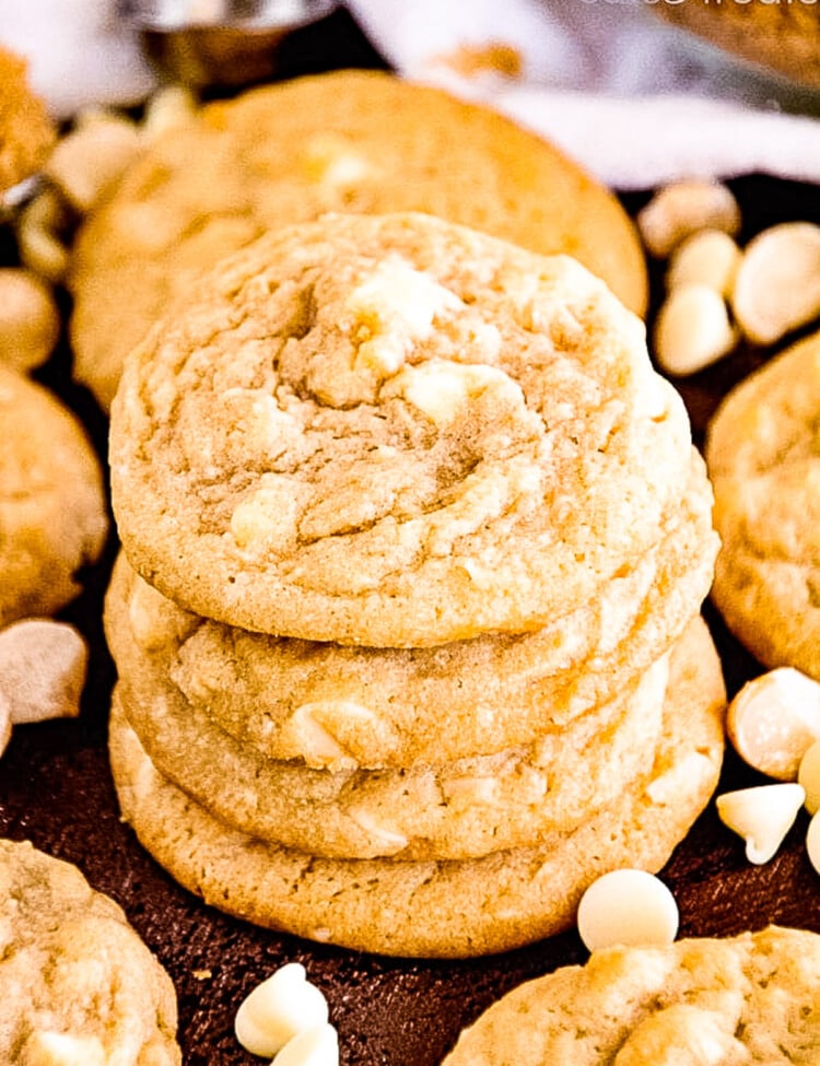 Stack of White Chocolate Macadamia Nut Cookies with more cookies laying next to it
