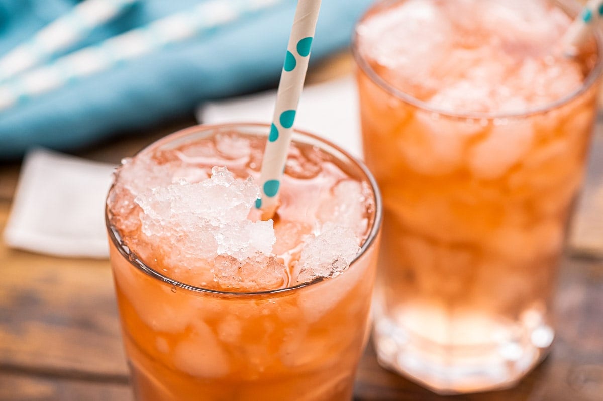 Close up image of arnold palmer drink in glass with blue napkin ground in back