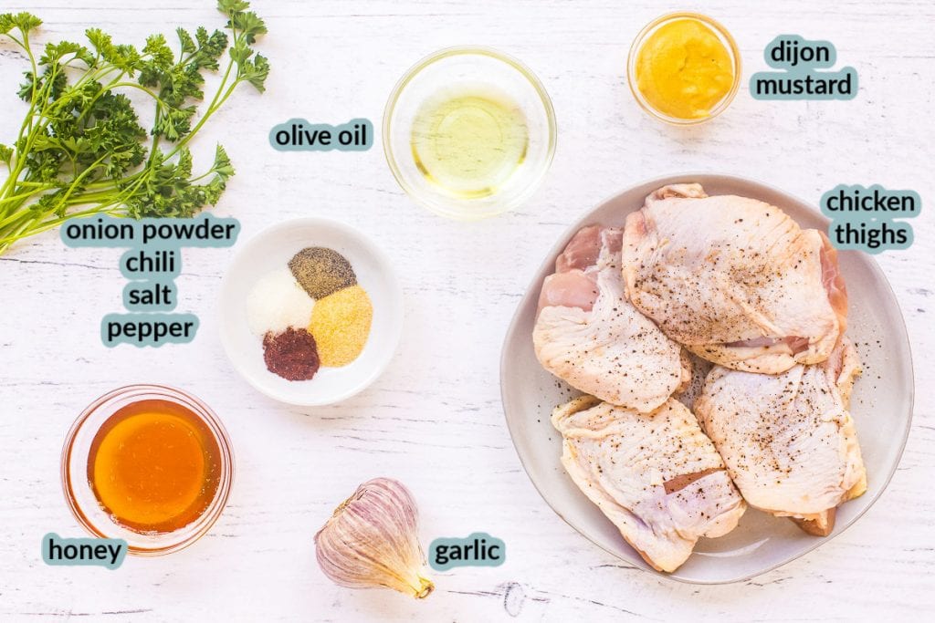 Ingredient for baked chicken thighs like chicken olive oil mustard spices honey garlic on white background