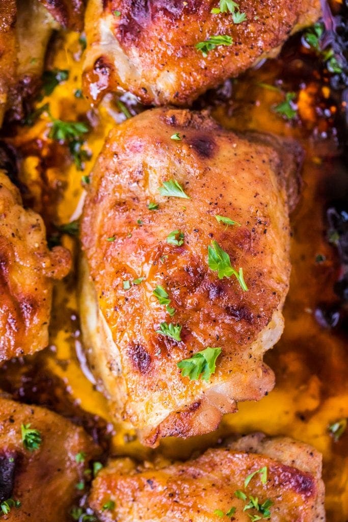 Overhead Image of baked chicken thighs in pan with drippings