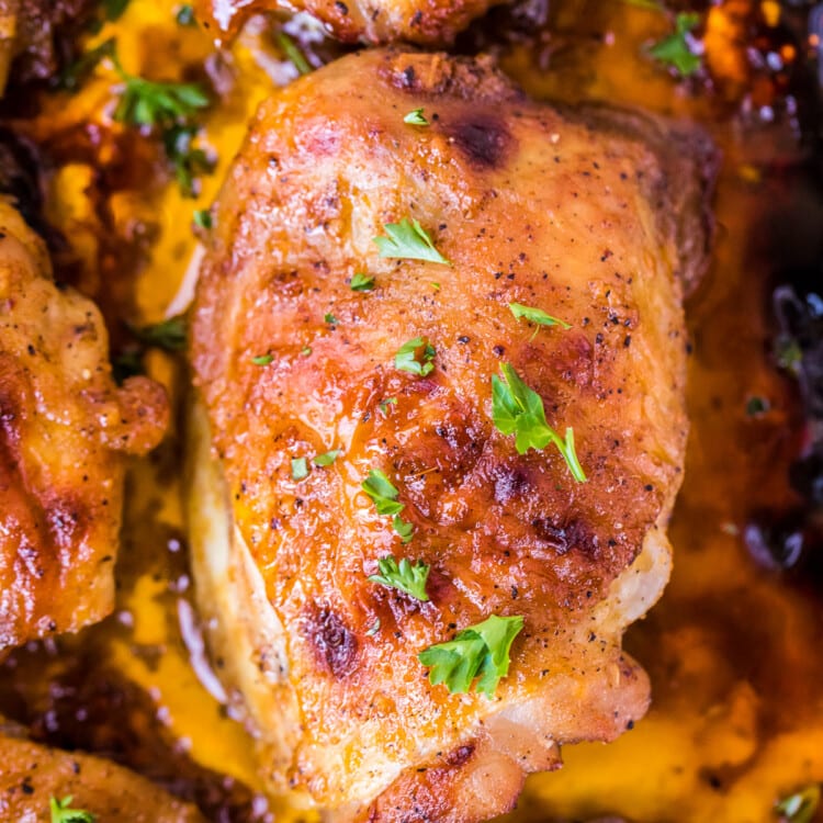 Overhead Image of baked chicken thighs in pan with drippings