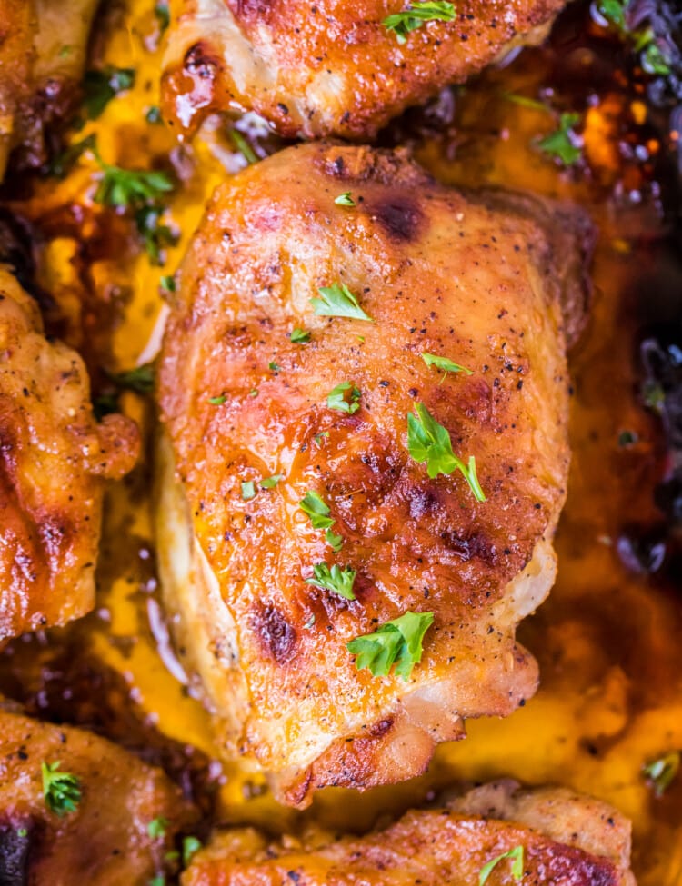 Overhead Image of baked chicken thighs in pan with drippings