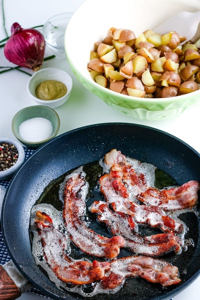 Frying pan with bacon and grease in it.