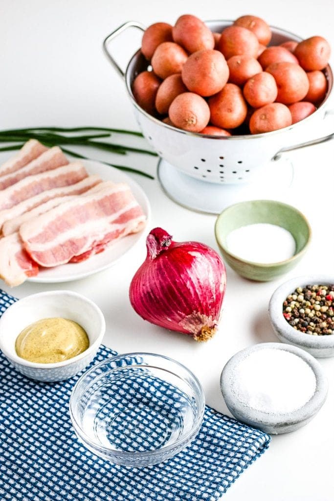 Image showing ingredients for German Potato Salad including onion, bacon, red potatoes, salt, pepper and more.