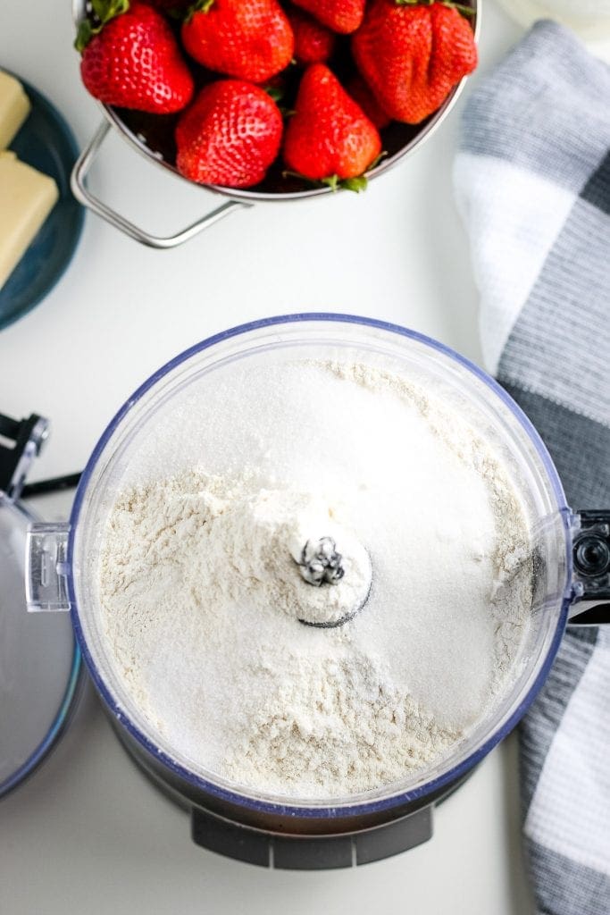 Dry ingredients in food processor bowl before being mixed.