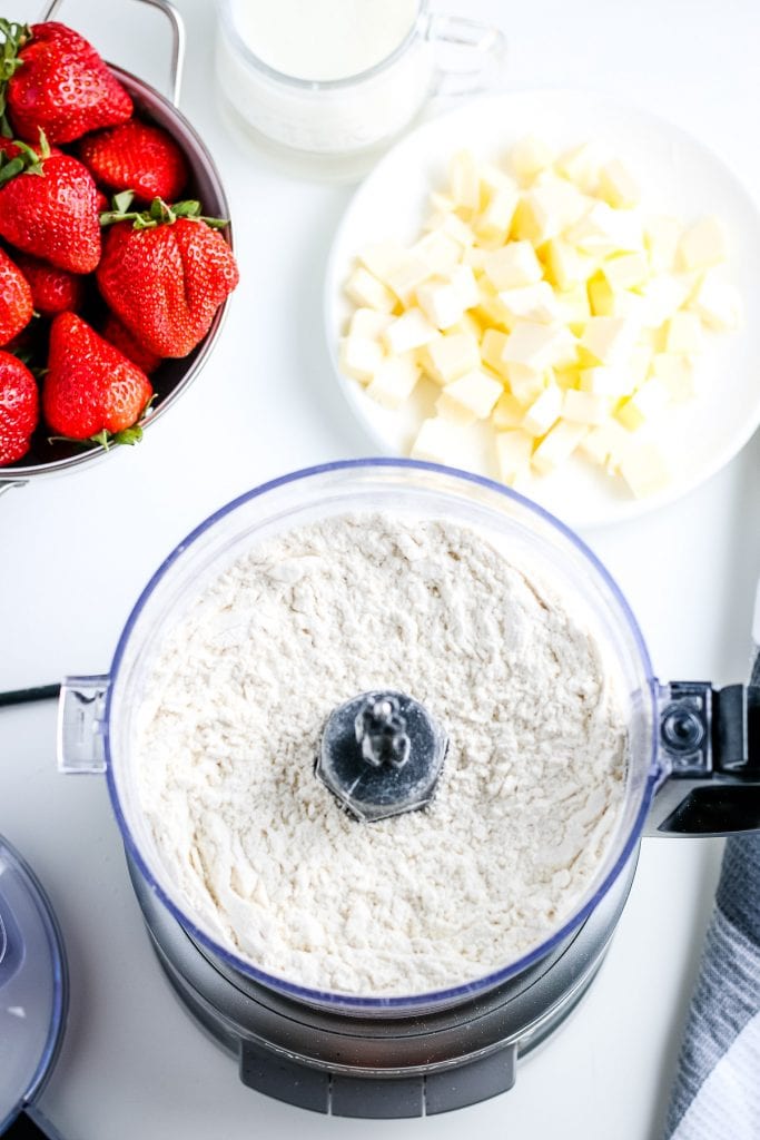 Dry ingredients in food processor bowl after being mixed.