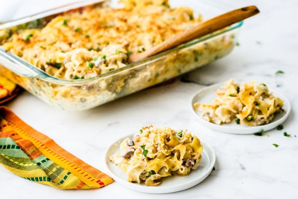 White background with casserole on two plates and casserole dish in background