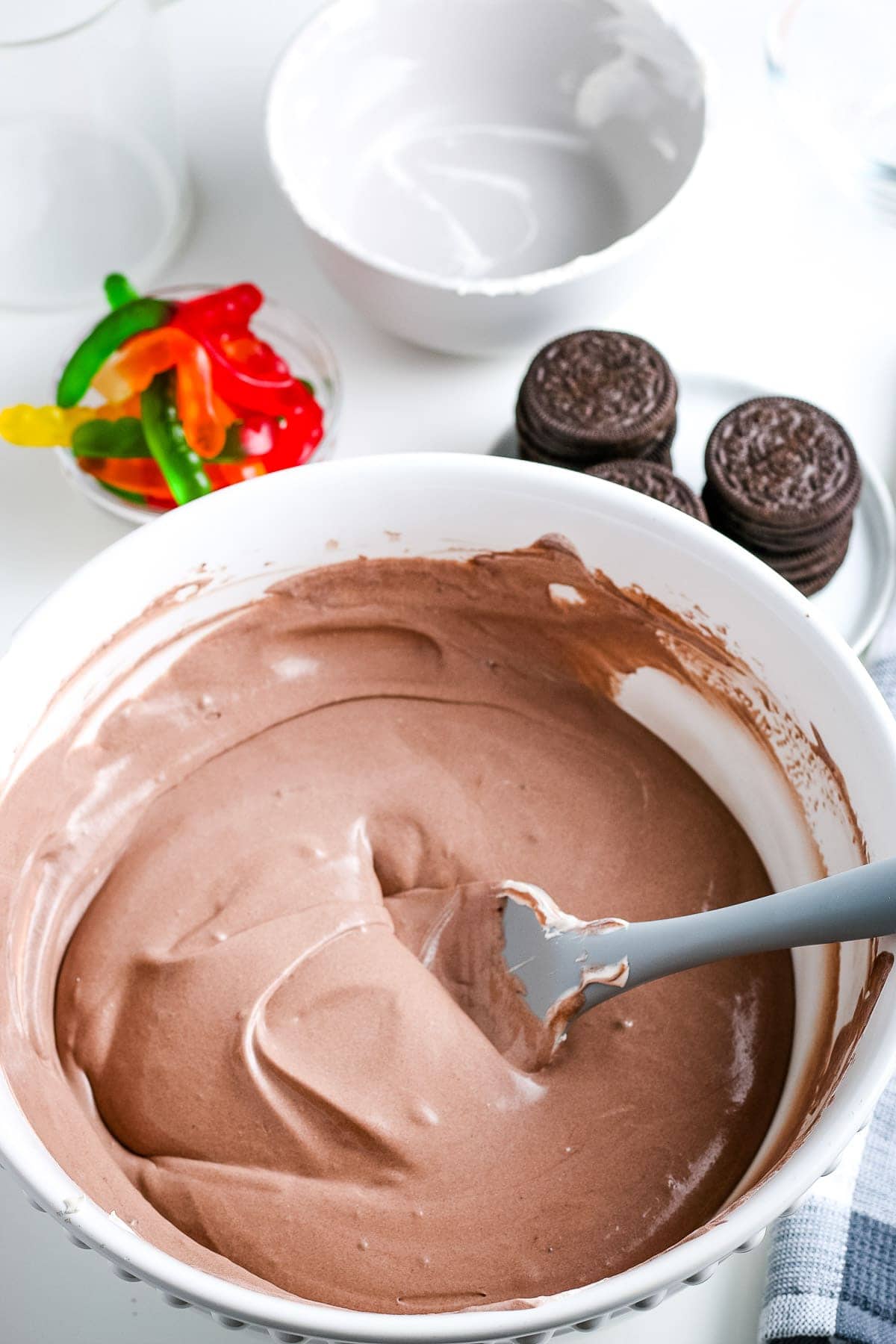 White bowl with Cool Whip and chocolate pudding after mixing together.