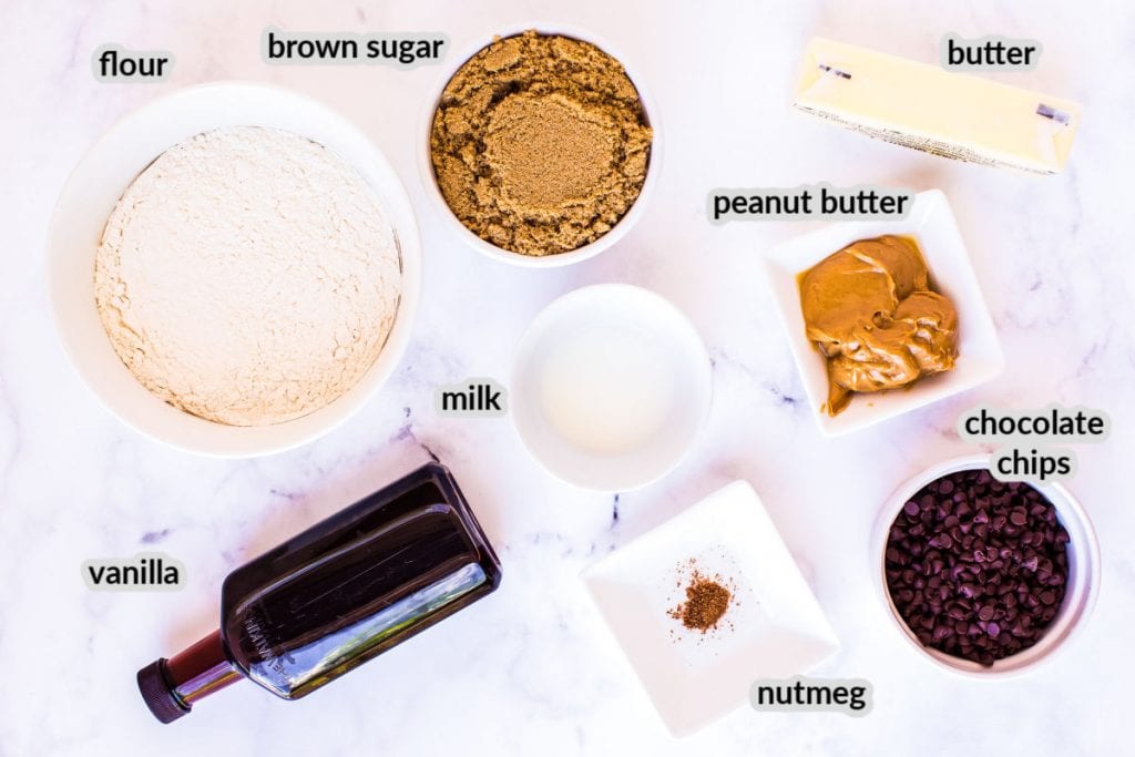 Overhead image showing ingredients to make Edible Cookie Dough. Ingredients shown are flour, brown sugar, butter, peanut butter, milk, chocolate chips, nutmeg and vanilla.